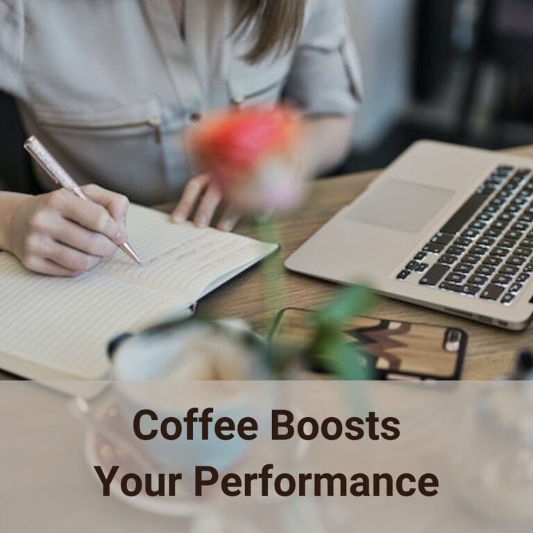 A girl sits at the desk with a laptop in front of her, slightly to her left side. She is writing something in a paper notebook while a cell phone and a cup of coffee are sitting on the desk in front of her slightly to her right hand. Coffee boosts your performance is known fact.