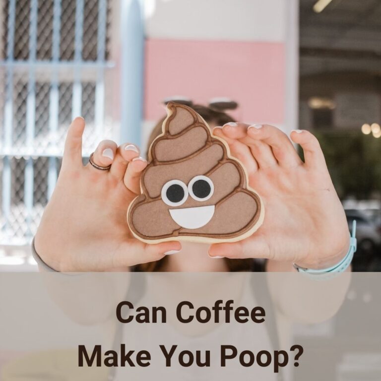 A woman holds up a emoji poop sign with her two hands. Her arms extends to the full and the sign blocks her face as if she is hiding behind the sign. She wears white nail polish and a wedding band on her right ring finger. Her left wrist wears a pale pastal blue strap wrist watch, on her right wrist a grayish beige hair tie is on there. It seems like she is standing outside a store front, maybe a coffee shop since a blurry dark opening can be made out as a door. Right behind her to the left of that opening is the store external wall which has wide pink and grey horizontal painted strips. Is there a connection between coffee and bowel movements? Yes, and there are some scientific reasons behind it.