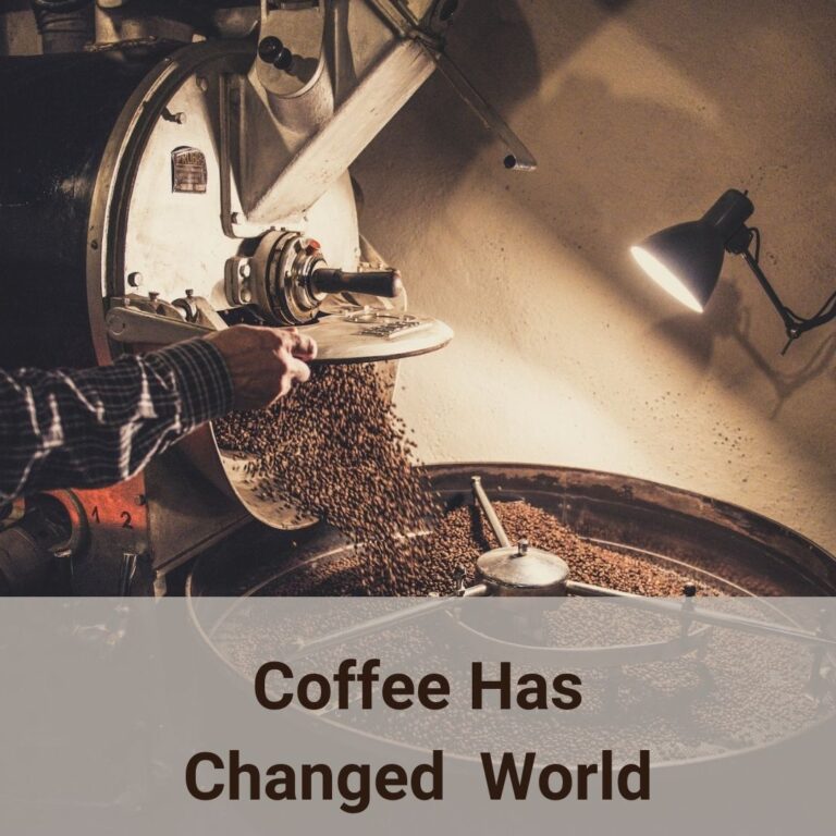 It is a photo about coffee roaster. In the picture only partial of the modern coffee roaster is visible. The coffee is roasted and is pouring into the cooling pan from the roaster. A man's right hand lift the roaster's shutter is visible. From the sleeve of the forearm, we can make out that he is wearing a flannel long sleeve buttoned up shirt. The round cooling pan with mesh is in the foreground of the picture and is about 1/3 of the picture from the bottom. A flexible arm work ligh on the middle right of the picture is shown liting up this corner of the roaster operation. Over many centries, coffee has changed the world in different ways.