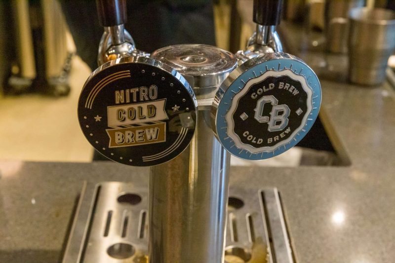 Nitro cold brew and Cold brew coffee served on tap, just like beer served on tap. The left, black and gold tap is for Nitro Cold Brew and right sky blue and black tap is for regular cold brew how to make nitro cold brew at home is a tricky yet simple question