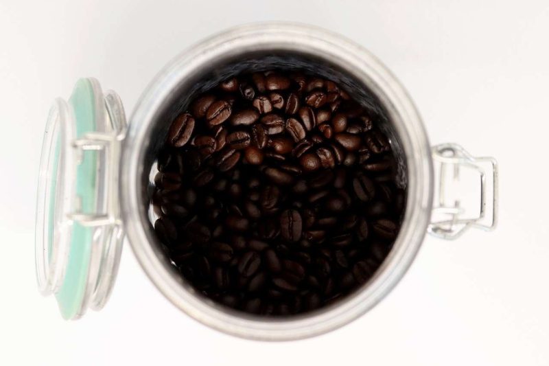 This is a top shot photo of a clear plastic food container contains roasted whole coffee beans. The container comes with a lid and lock system and airtight and water proof seal. The seal is in aqua blue. This kind of contrainer may keep the moisture and air out, but its transperant body does not keep the light out. It is not 100% good to store coffee. Can coffee go bad in that container? Yes, but it may take some time before the coffee goes stale.